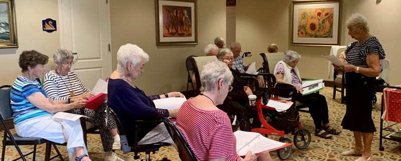 assisted living residents Aravilla Sarasota listening to history lecture