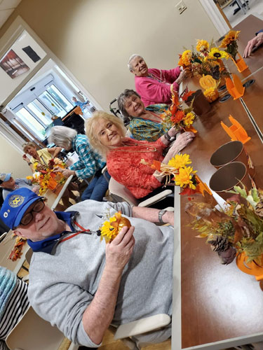 memory care residents sitting in a gazebo