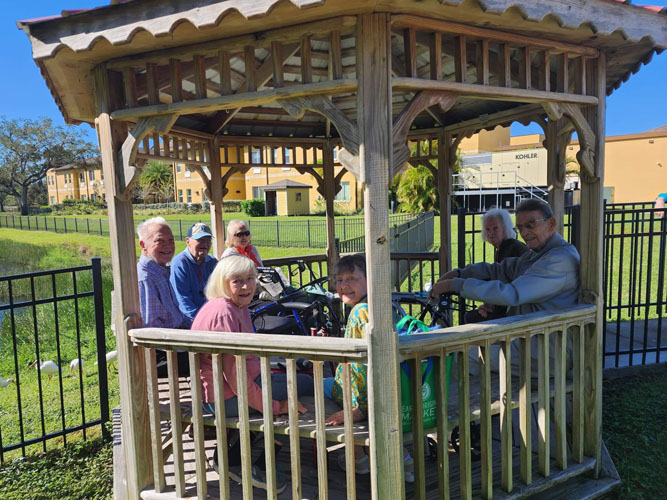 memory care residents sitting in a gazebo