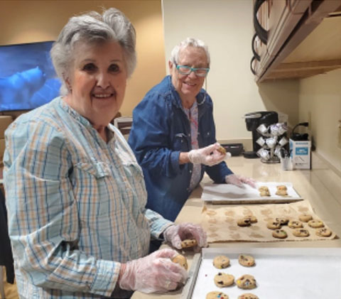 memory care residents having fun baking