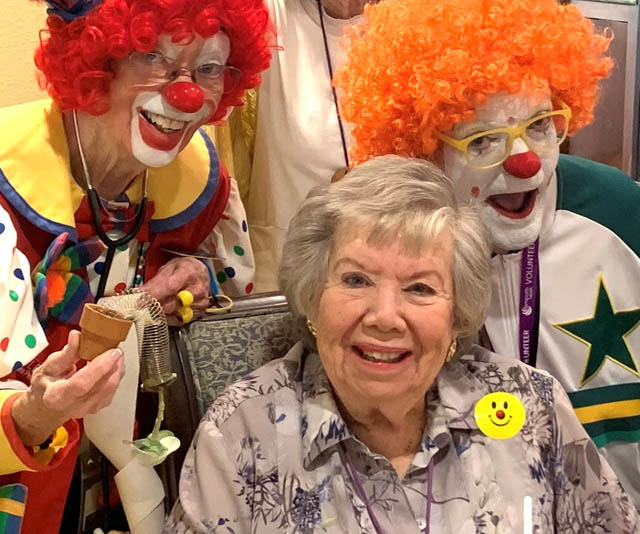 Assisted Living Aravilla Sarasota resident Dale smiling with clowns