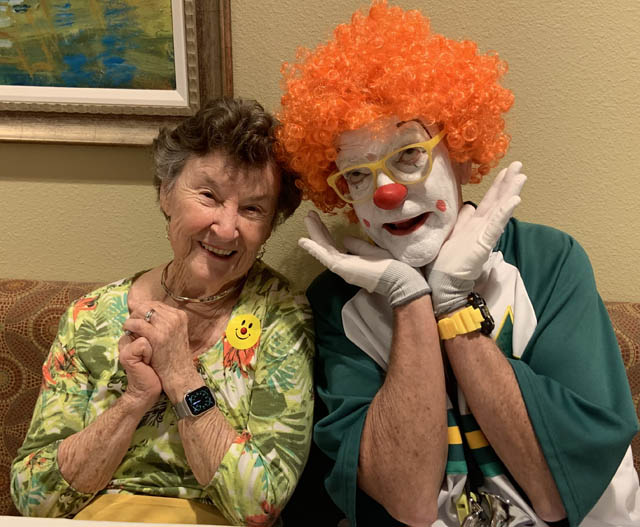 assisted living resident betty smiling with clown