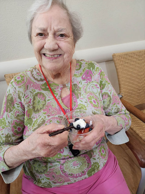 memory care resident sitting eating parfait