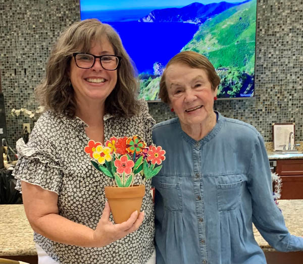 assisted living resident with flower craft