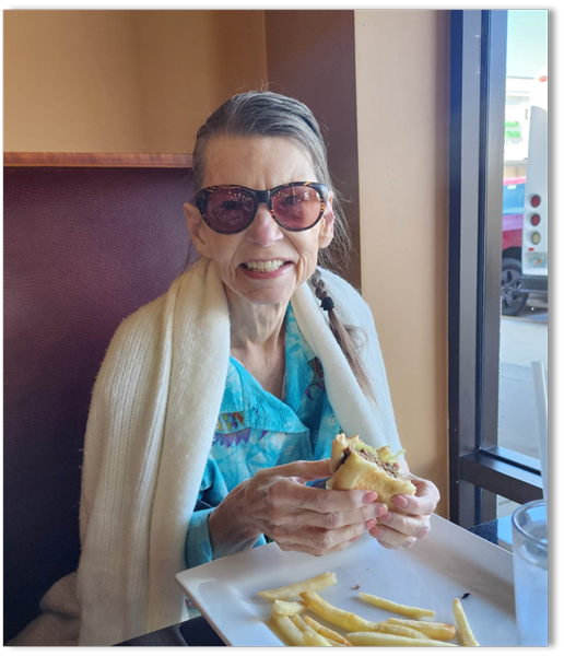 memory care resident smiling at lunch