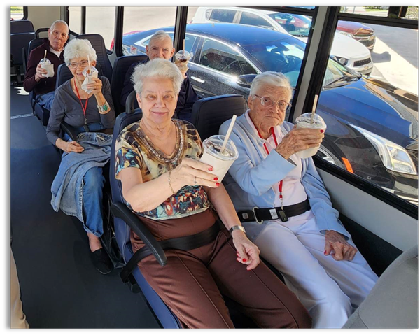 memory care residents sitting on the bus with milk shakes