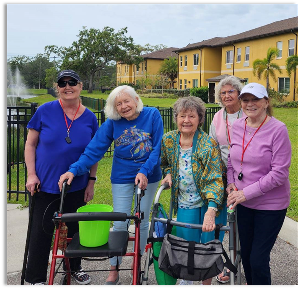 memory care residents taking a stroll in the gardens