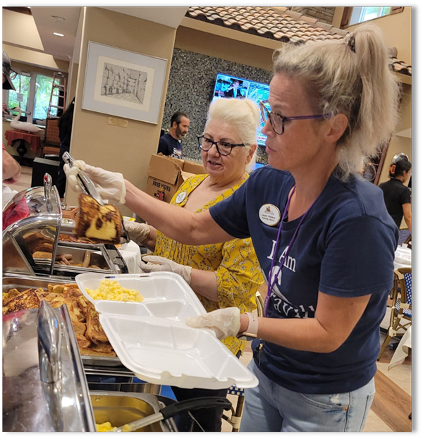 Aravilla staff serving hot food at the buffet