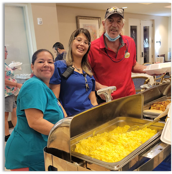 Aravilla staff smiling at the breakfast buffet