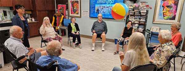 assisted living residents exercising with beach ball