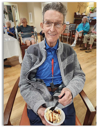 memory care resident eating an ice cream sundae