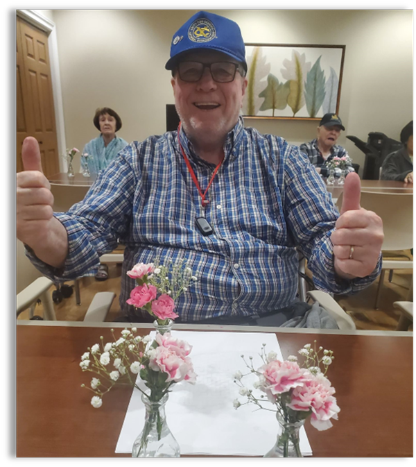 memory care resident making flower arrangements