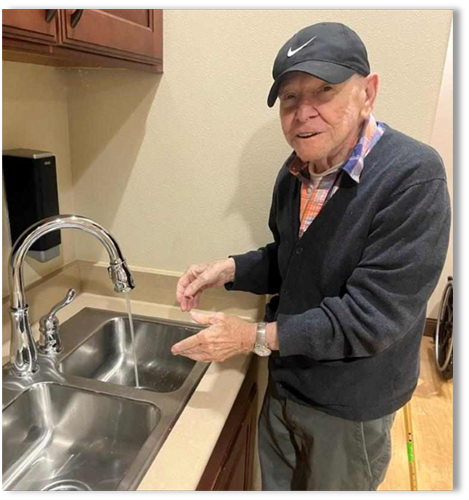 memory care senior resident washing hands
