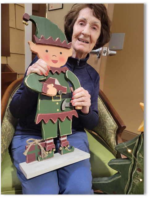 memory care resident Susie holding a Christmas Elf