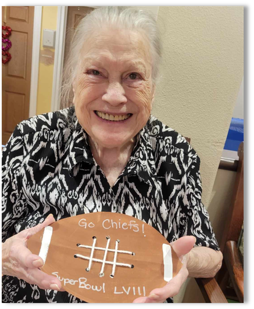 memory care resident with football craft