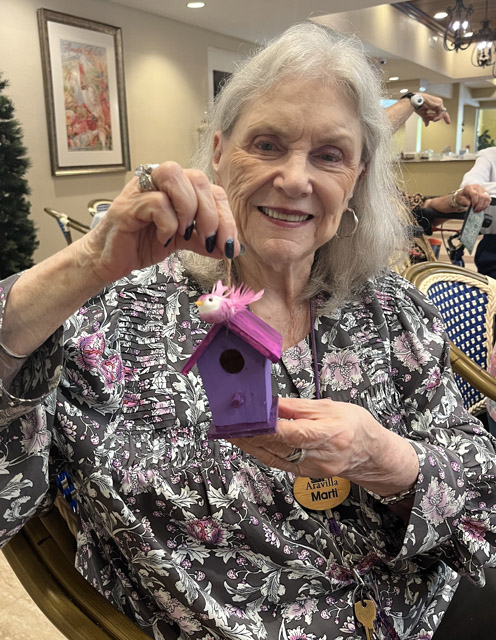 assisted living resident with bird house