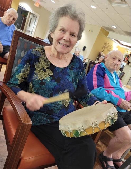 memory care resident playing drums