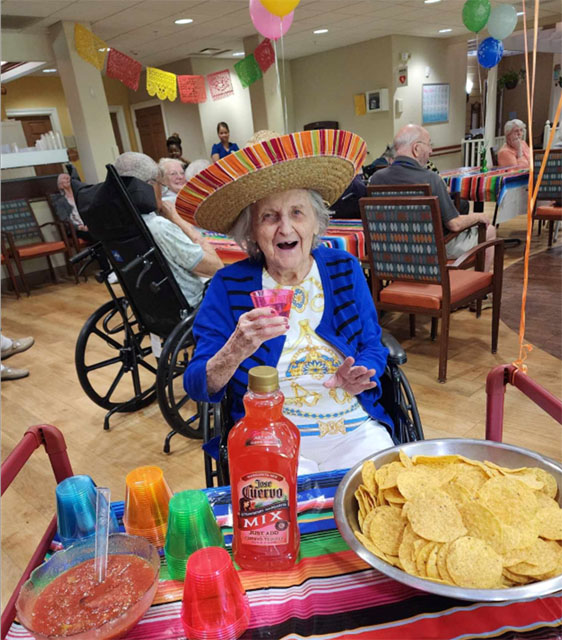 memory care resident celebrating Cinco de Mayo wearing a Sombrero