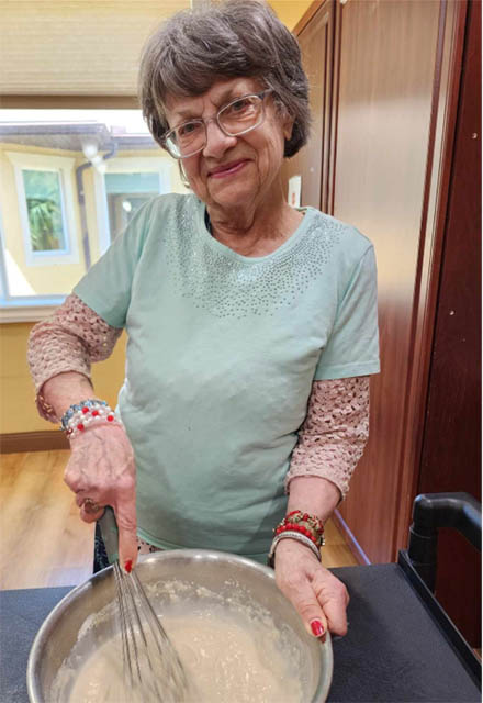 happy memory care resident whisking