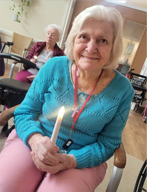 resident with lit candle