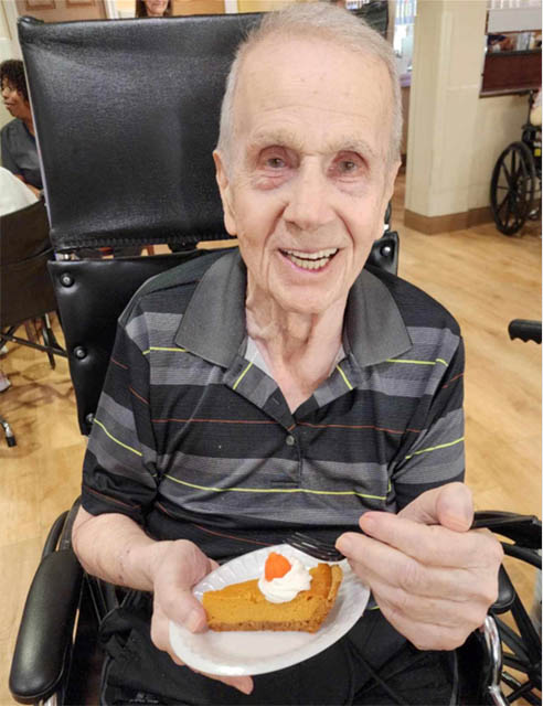 happy memory care resident enjoying dessert