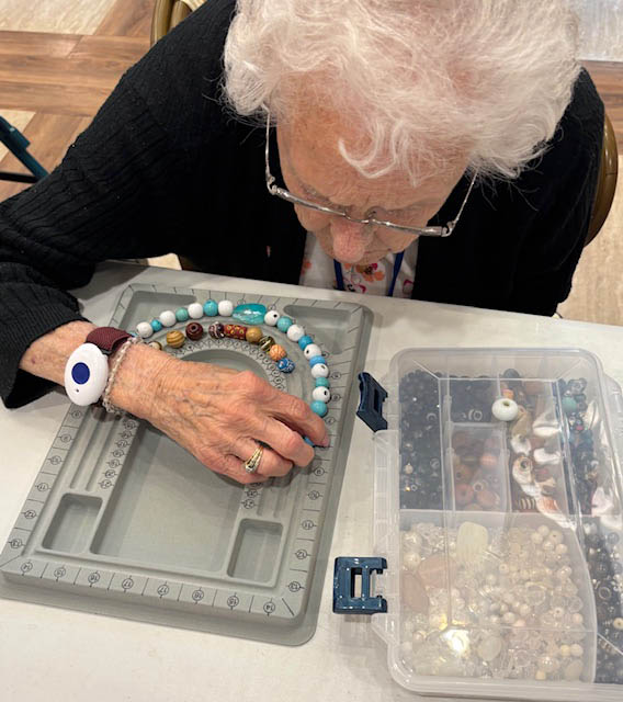 senior enjoying jewelry making