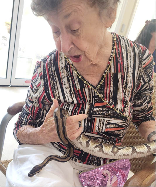 memory care resident holding a snake