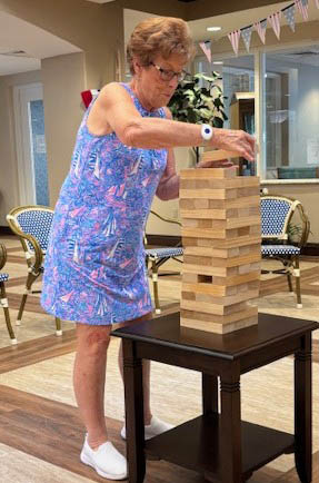 senior resident Cece playing jenga senior resident Cece playing Jenga