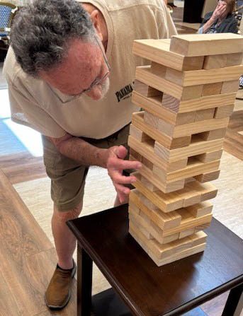 senior resident Ernie playing jenga senior resident Ernie playing Jenga
