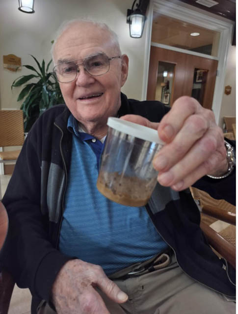 senior resident excited about butterfly hatching