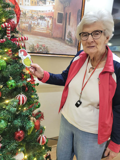 memory care resident with Christmas tree ornament