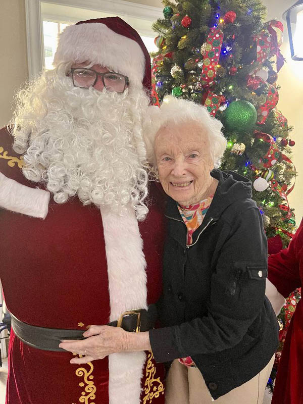 senior resident with Santa smiling