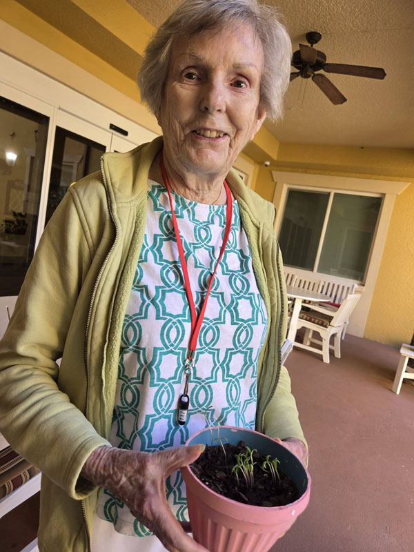 memory care resident planting flowers
