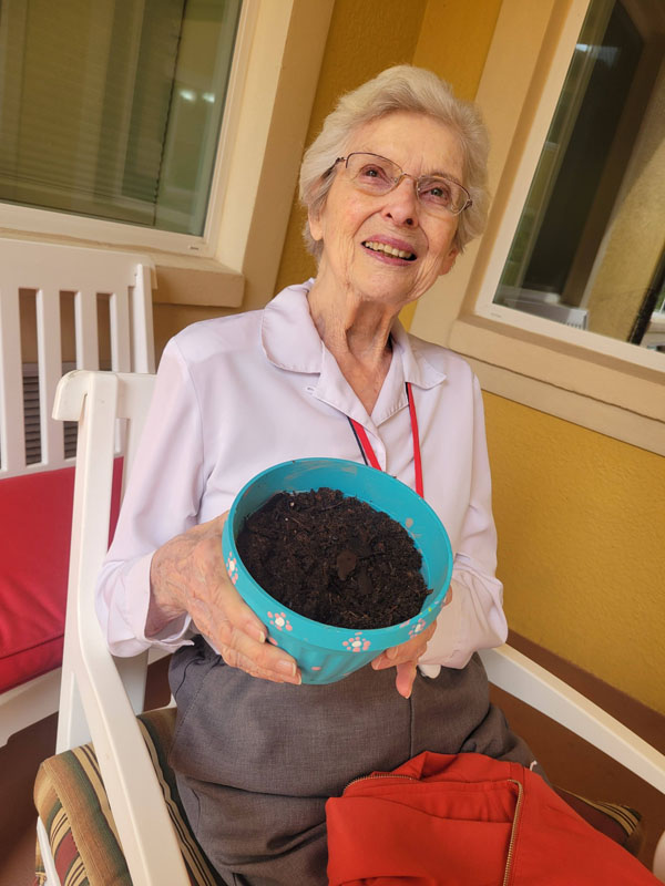 happy resident working on flowerpot project